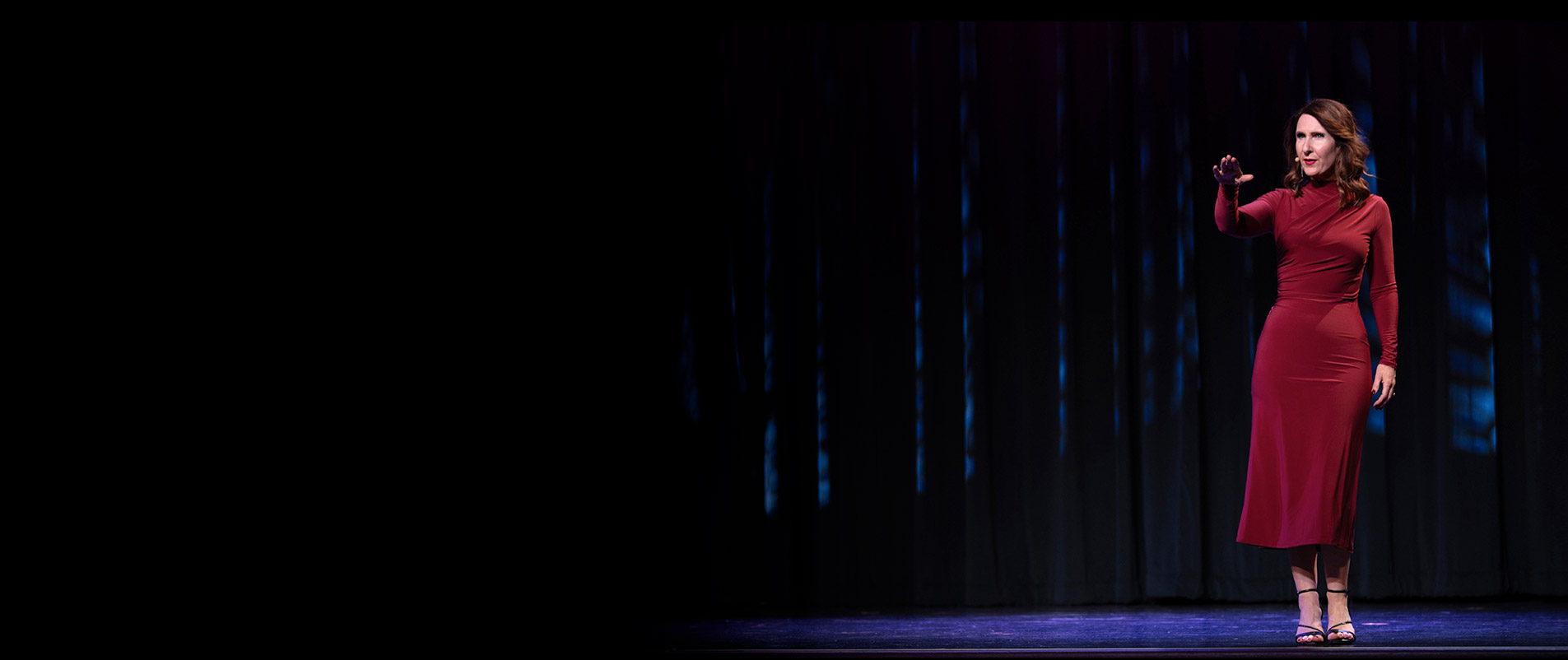 Rachael-Jayne on stage with a beautiful dark red dress