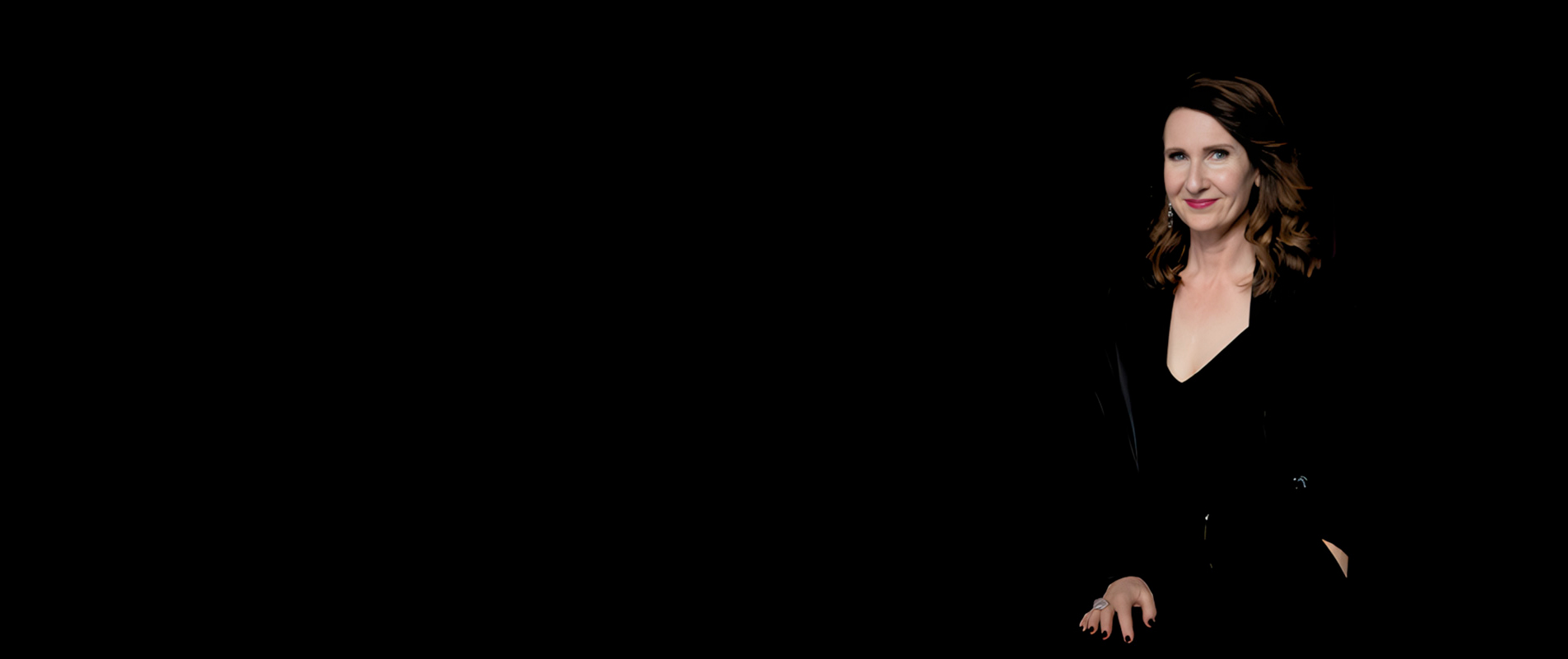 Rachael-Jayne on a dark stage