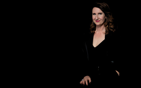 Rachael-Jayne on a dark stage