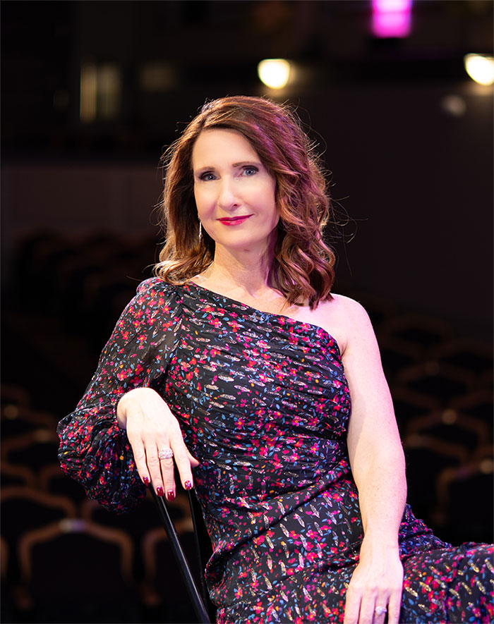 Rachael-Jayne seated on stage